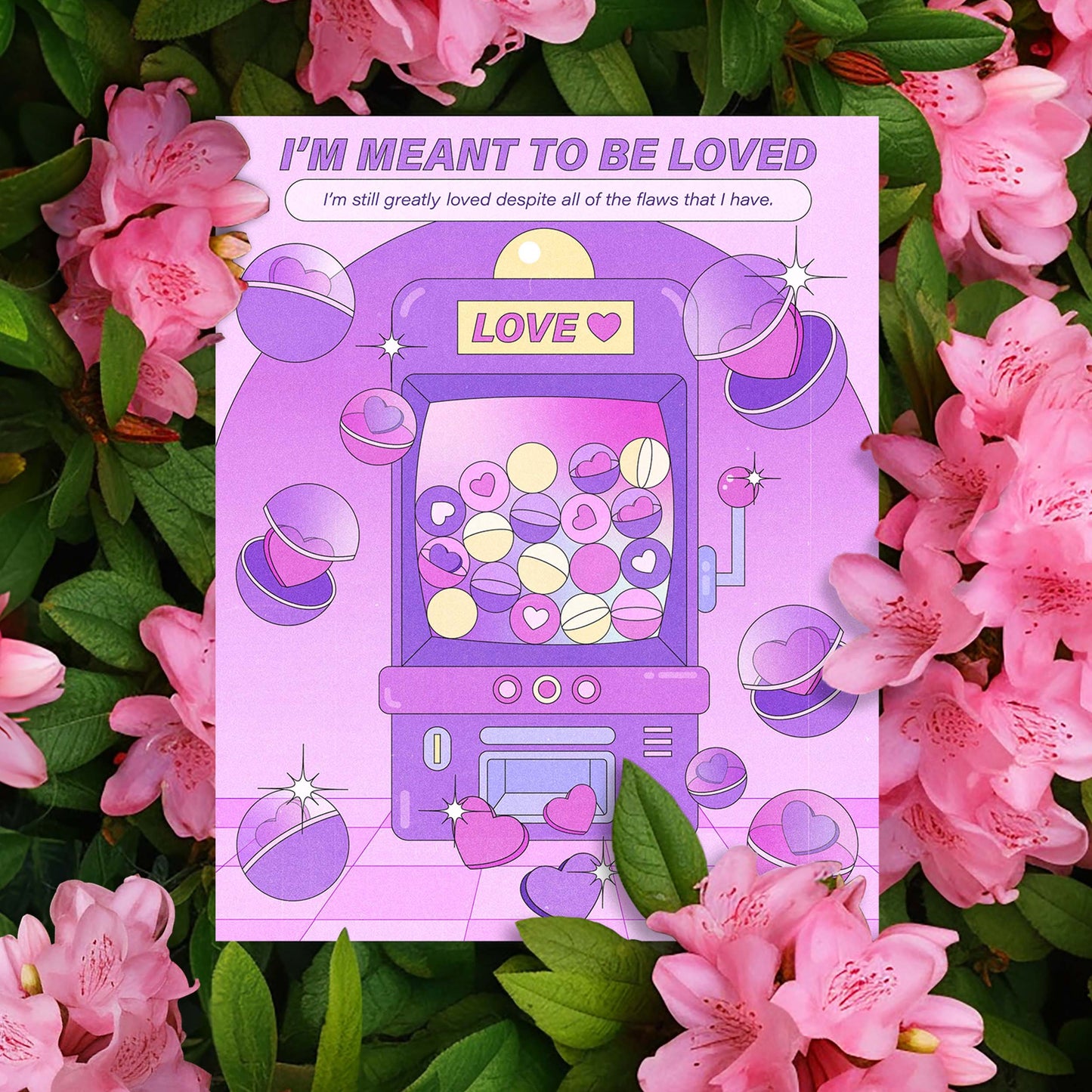 A purple claw machine self-care art print with the text "i'm meant to be loved" against pink floral background